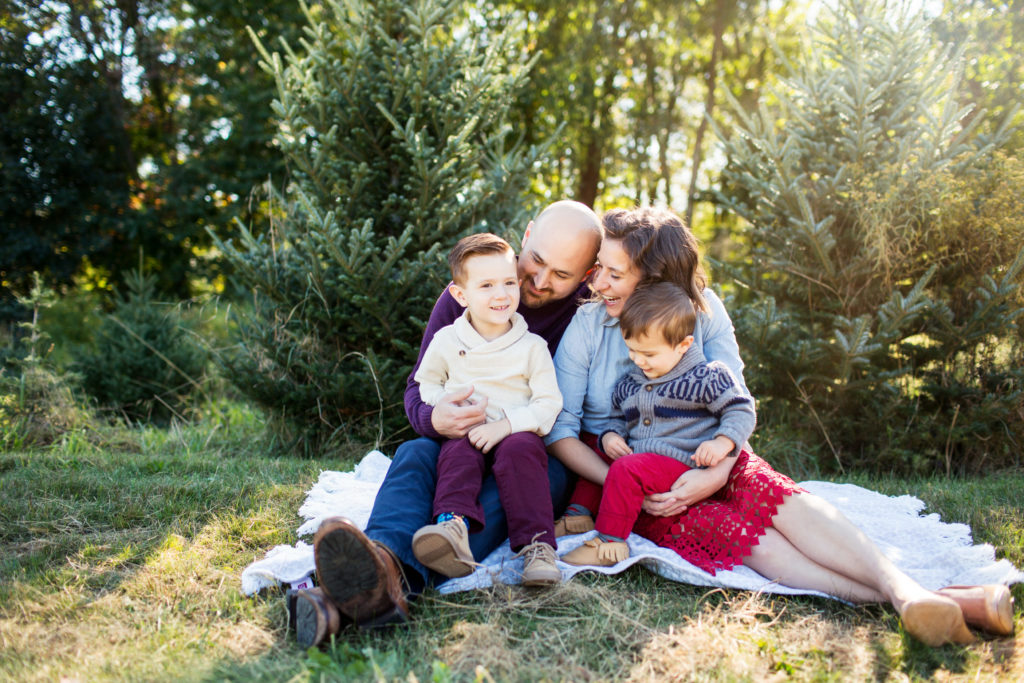family sitting on ground at christmas tree farm - hopkinton family photographer