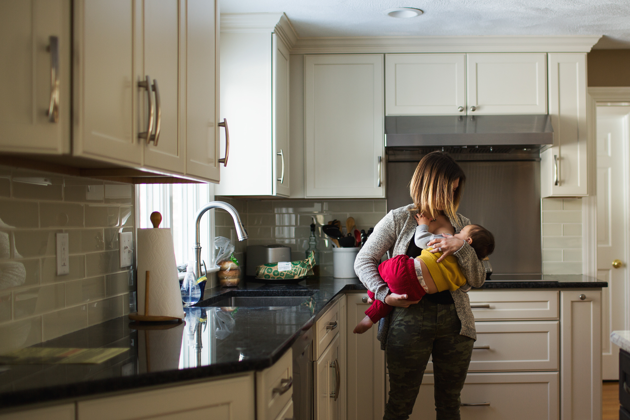 mother nursing toddler in kitchen - hopkinton photographer