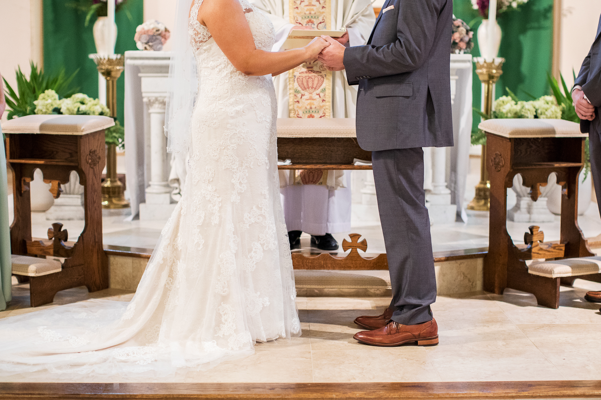 couple holding hands at church altar - ct wedding photography