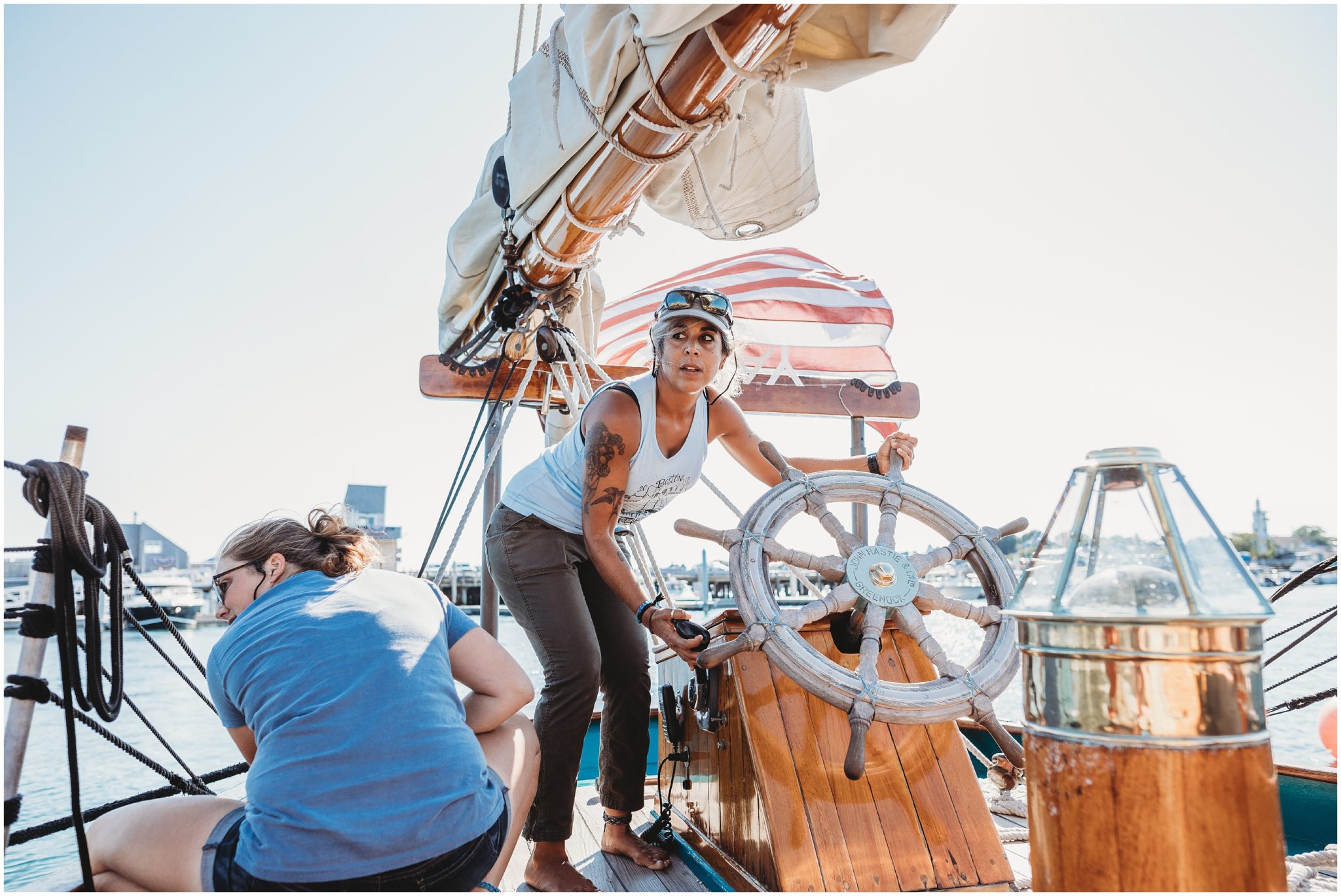 boat captain turning wheel - boston elopement photographer