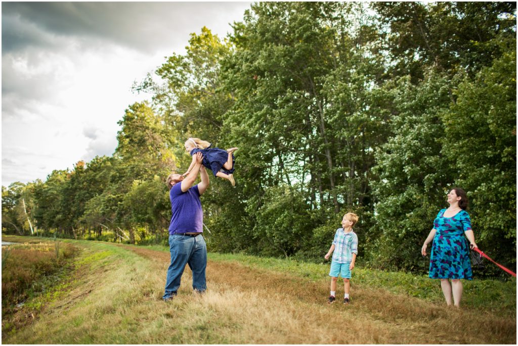 father tossing daughter in air - framingham photographer