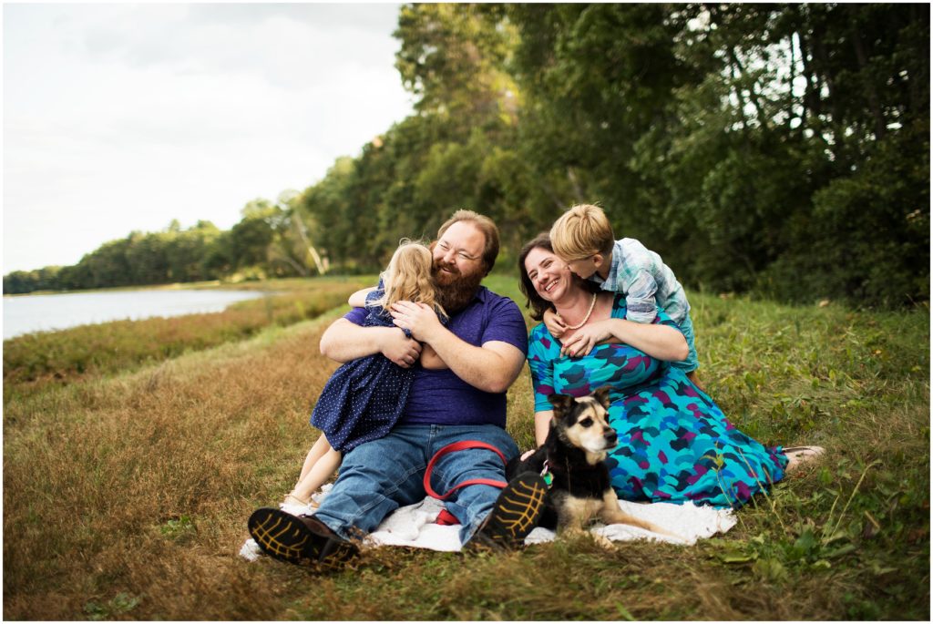 family and dog sitting on blanket outdoors - boston family photographer