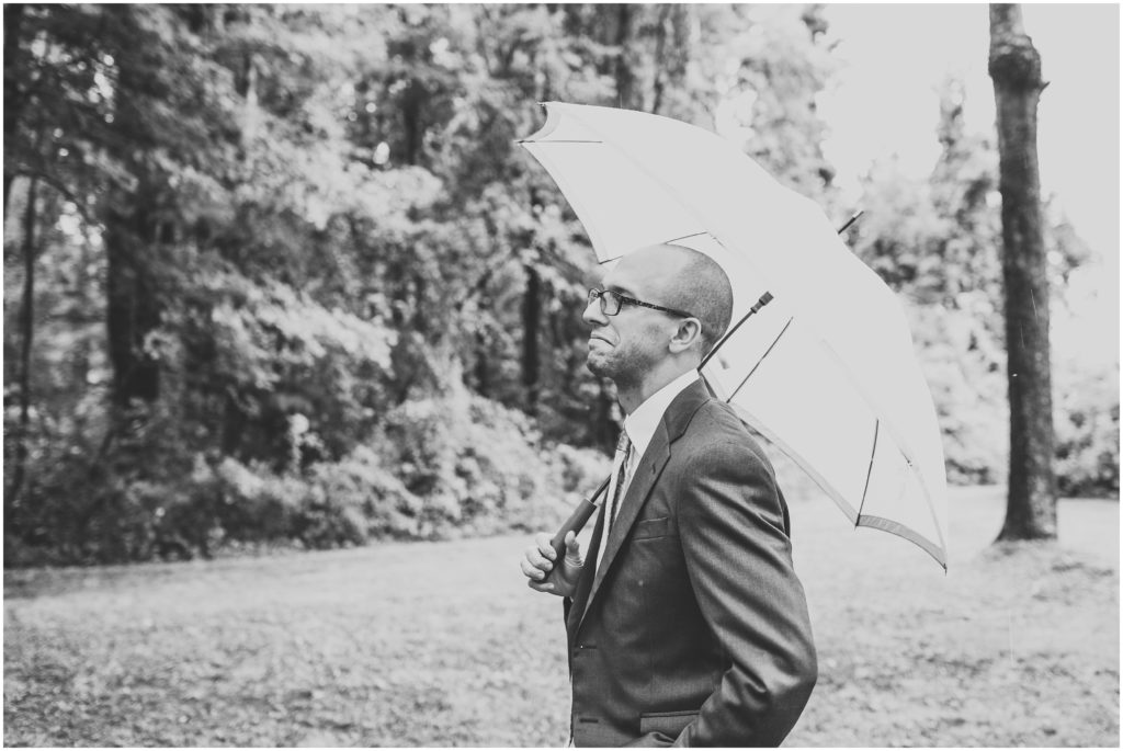 groom-in-rain-with-umbrella