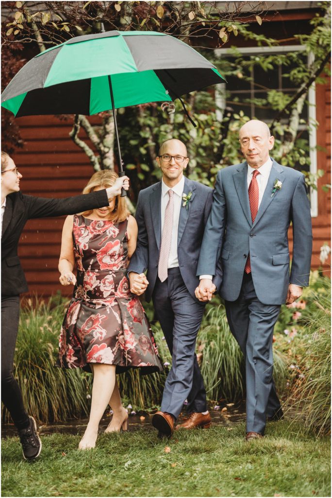 groom-walking-to-ceremony-with-parents