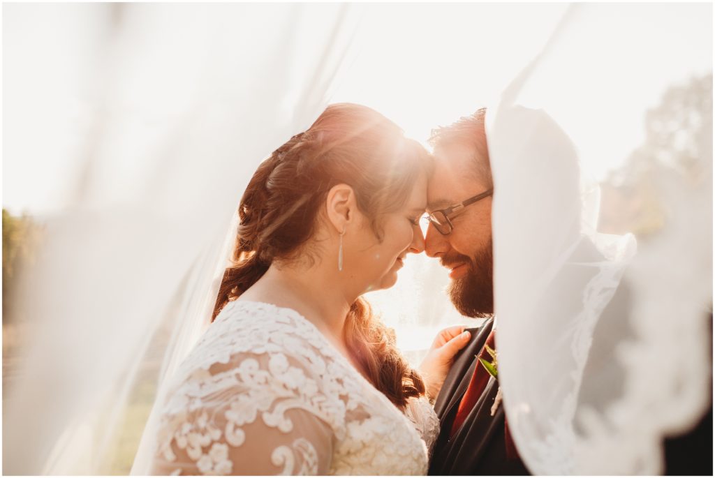 bride-and-groom-under-wedding-veil