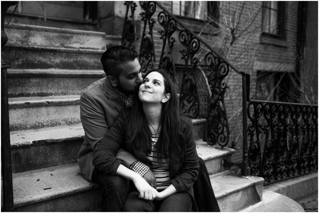 couple snuggling on front stoop - massachusetts engagement photographer