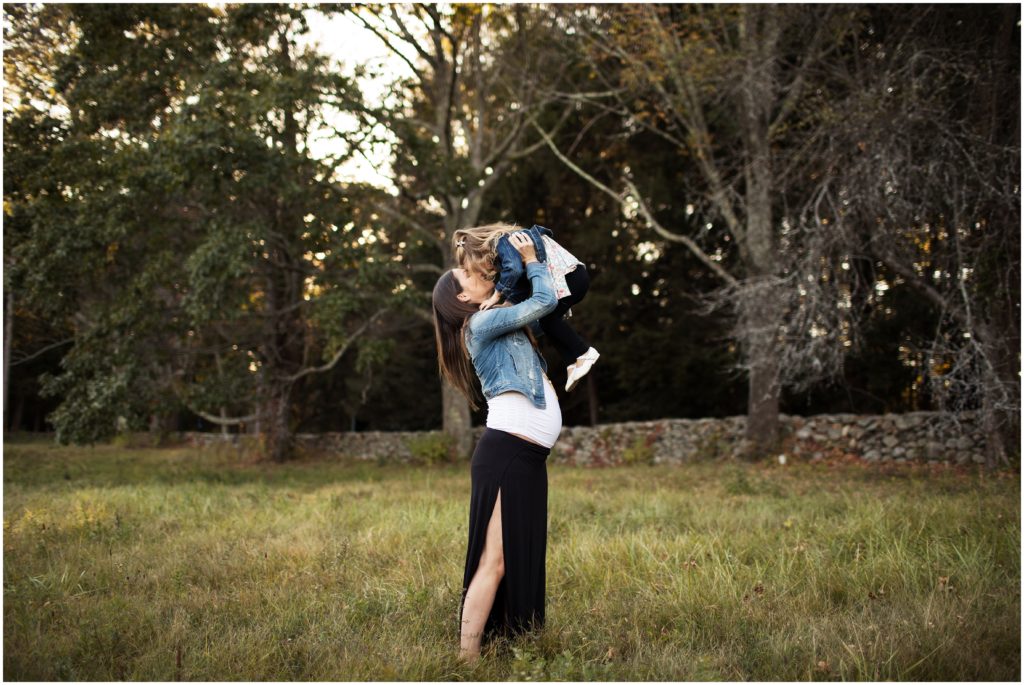 pregnant mother lifting daughter in field- boston maternity photographer