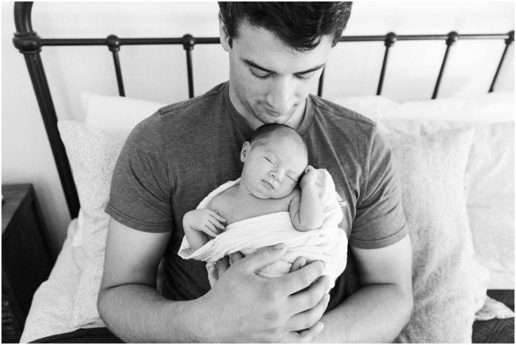 dad-holding-newborn-black-and-white-imagery