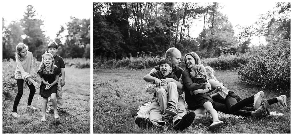 black-and-white-portrait-of-family-of-five-sitting-on-ground-outdoors