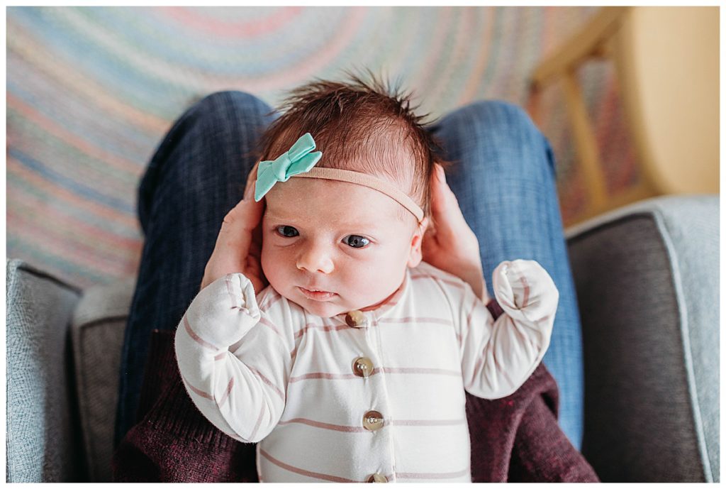 baby-laying-in-dads-hands-boston-newborn-photographer