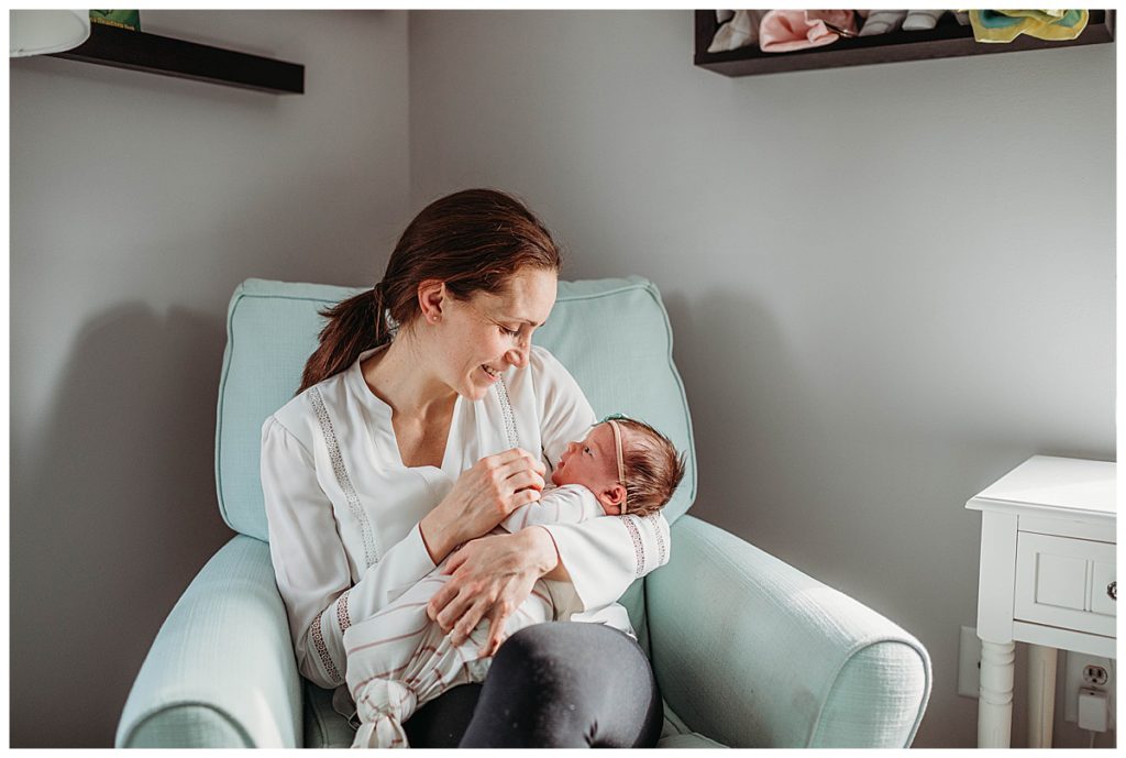 mom-holding-baby-in-aqua-rocker-boston-newborn-photographer