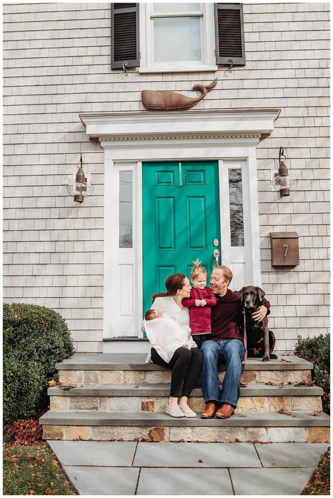 family-on-front-steps-with-teal-door-boston-newborn-photographer