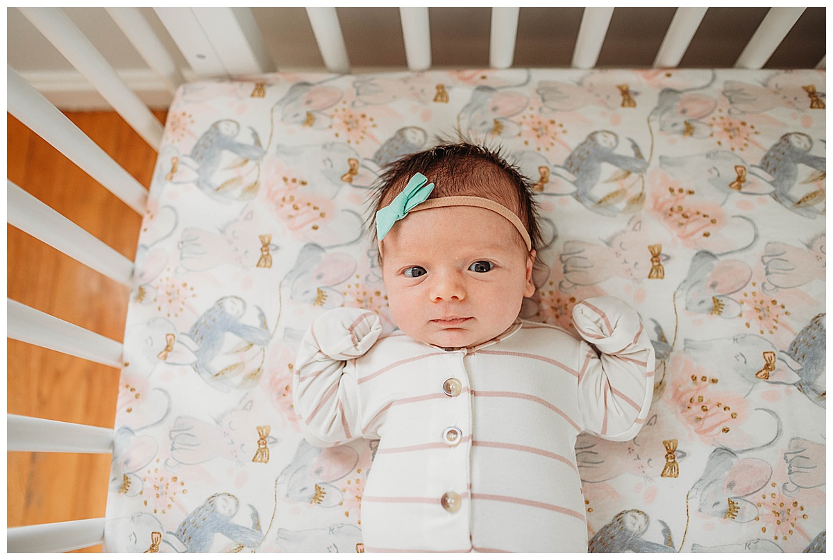 baby-girl-in-stripes-lying-in-crib-boston-newborn-photographer