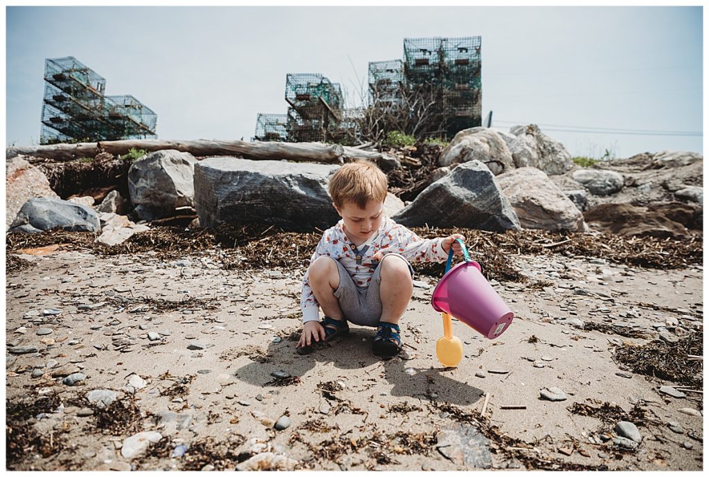 boy-playing-with-pail-in-sand-boston-family-photographer