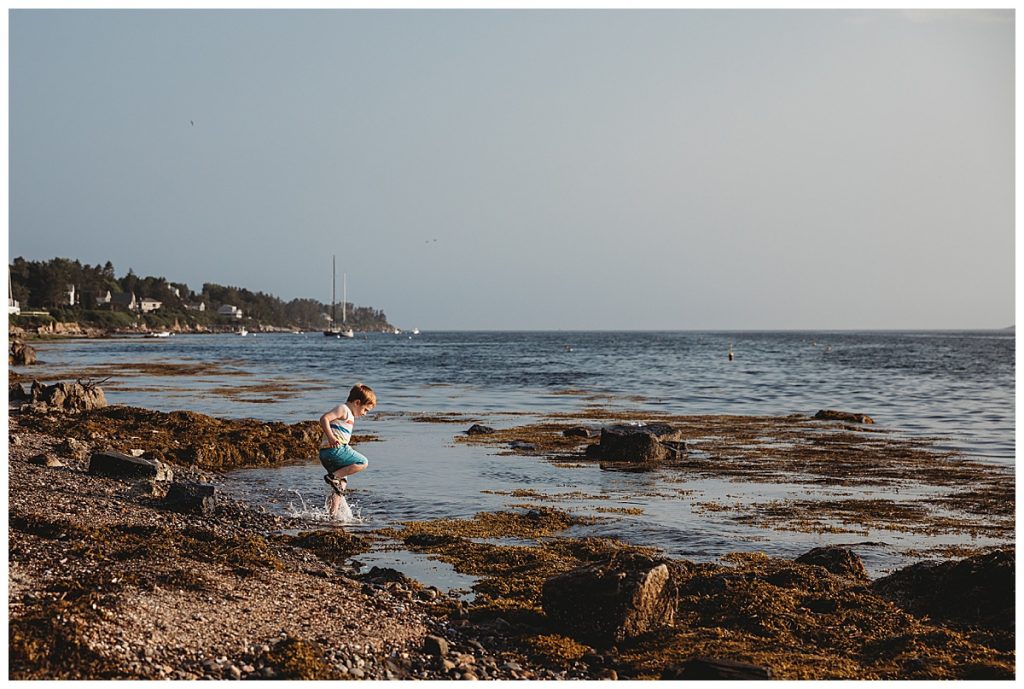 boy-stomping-in-waves-in-maine