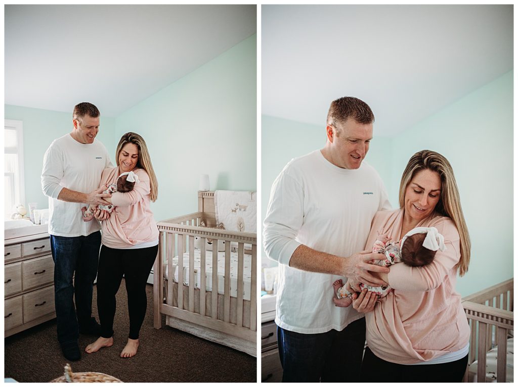 parents-standing-in-baby-girl-nursery-boston-newborn-photographer