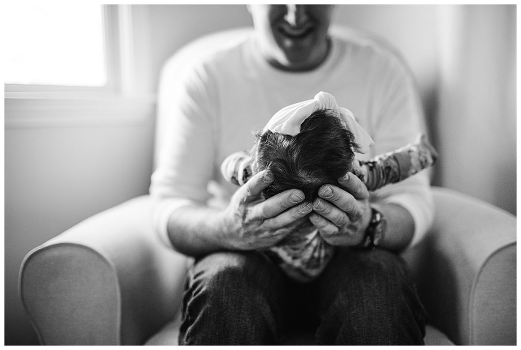 dad-holding-baby-head-in-hands-boston-newborn-photographer