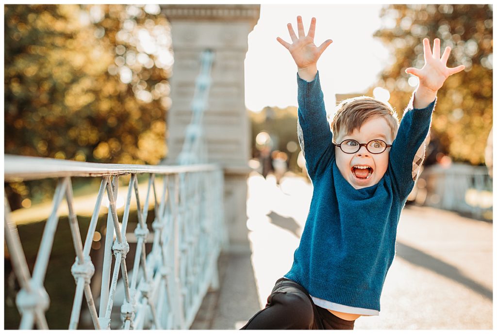 Boy-leaping-with-arms-in-air-on-bridge-boston-family-photographer