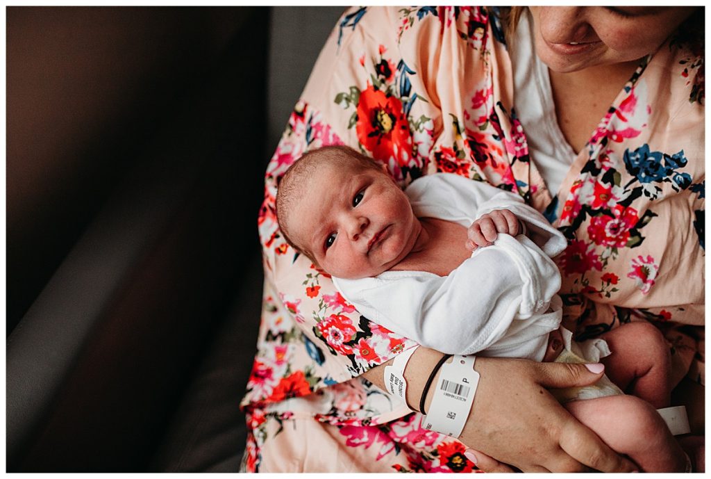 new-mom-holding-baby-in-hospital-with-floral-robe-boston-newborn-photographer