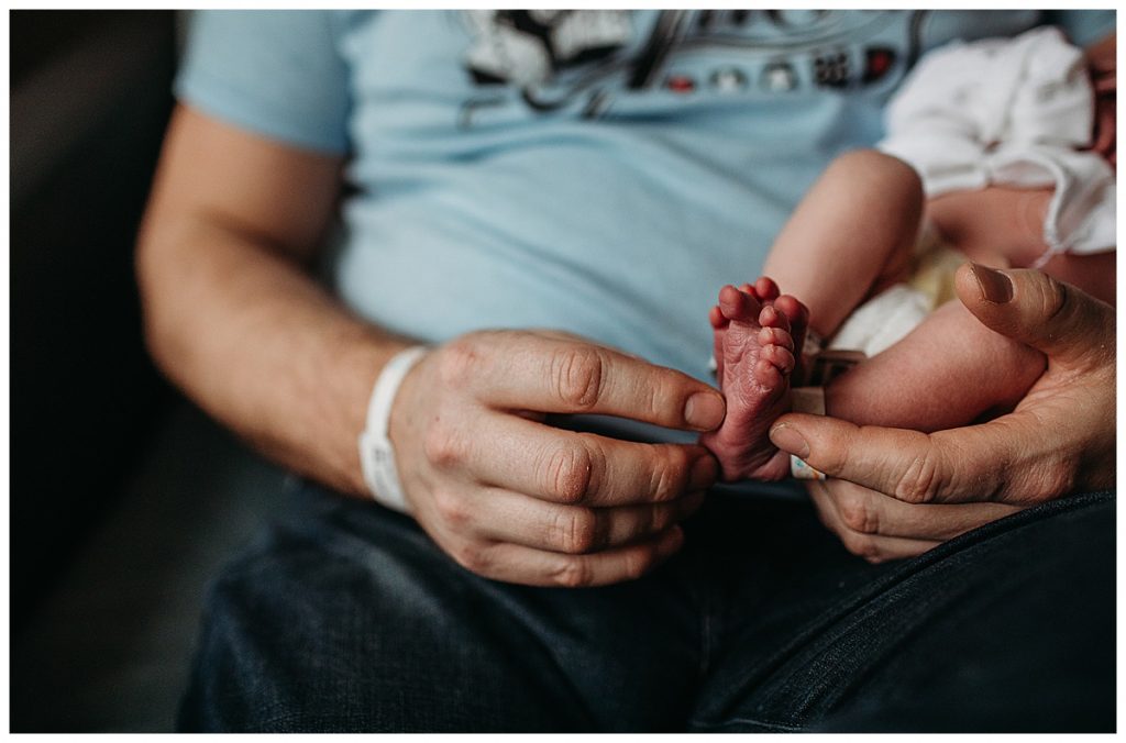 father-holding-newborn-sons-purple-feet-boston-newborn-photographer