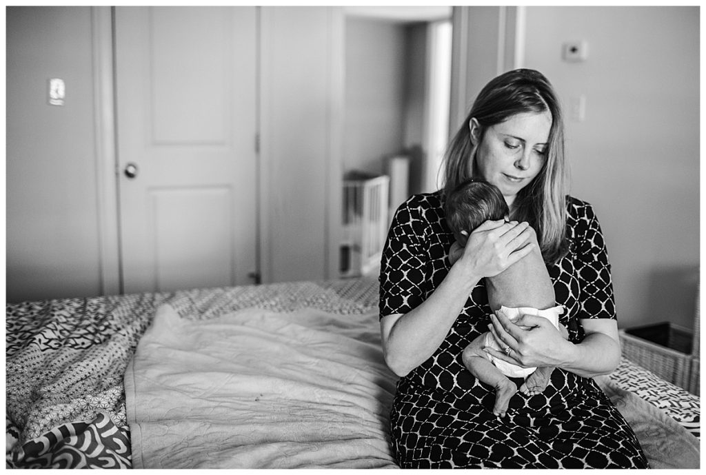 mother-holding-newborn-on-bed-boston-newborn-photographer
