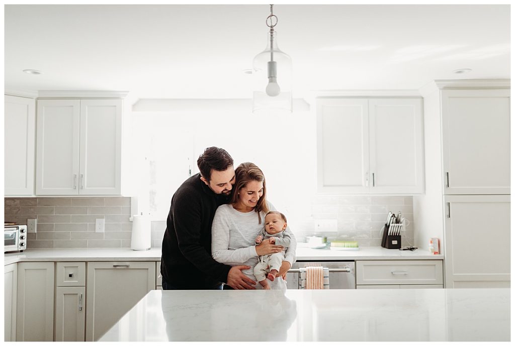 family-with-baby-boy-in-white-kitchen-sudbury-newborn-photographer