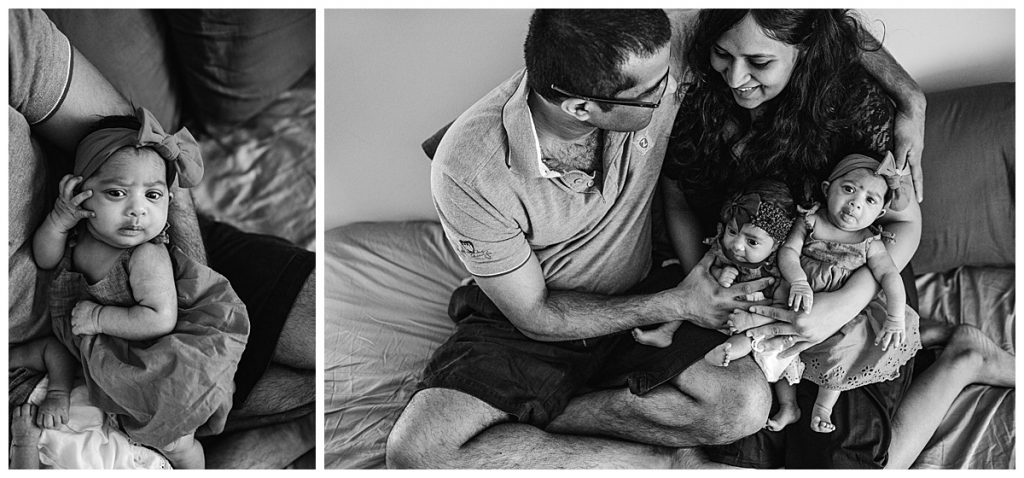 black and white portrait of twin babies in parents arms