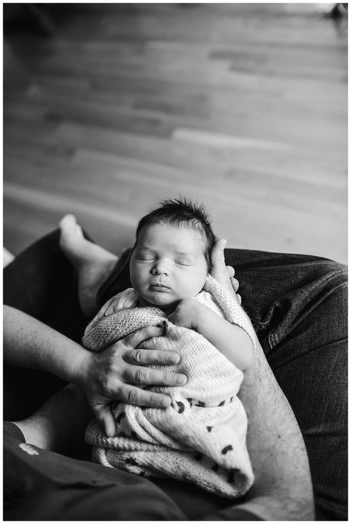 black and white portrait of a baby being swaddled