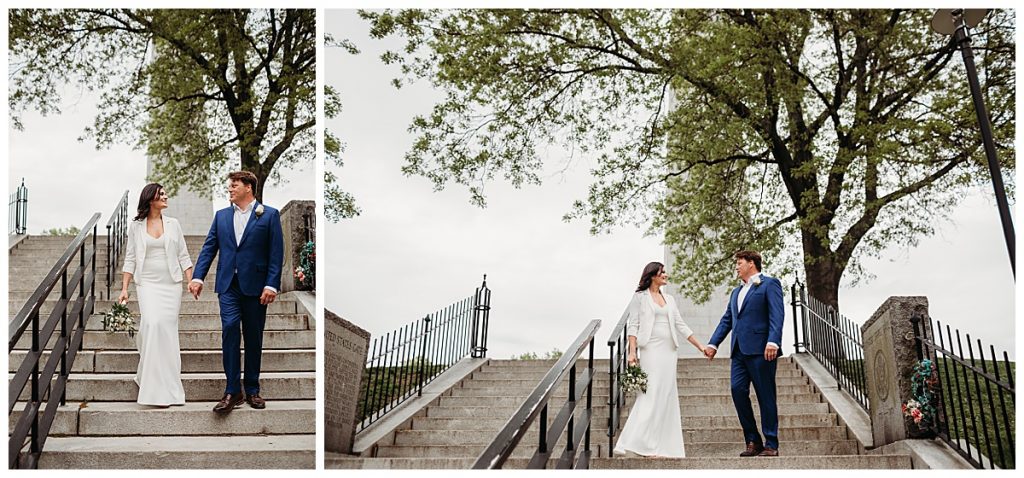 couple holds hands on the steps of the bunker hill monument during elopement
