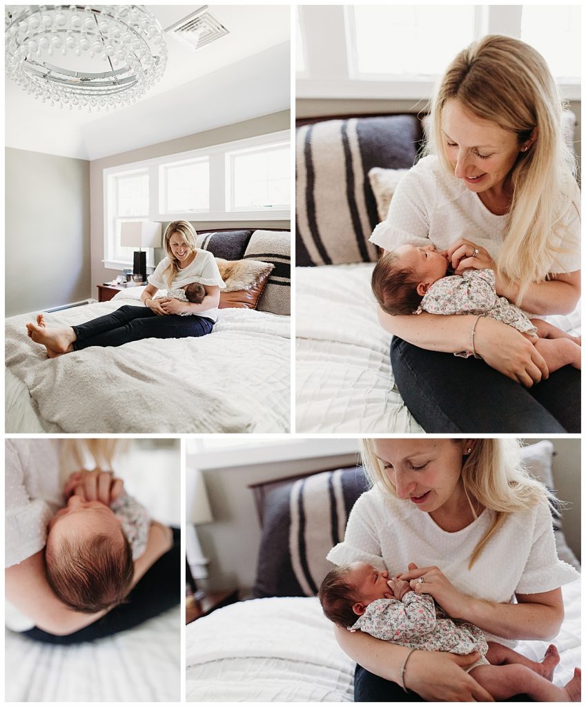 mom sits on bed holding newborn daughter during baby photos