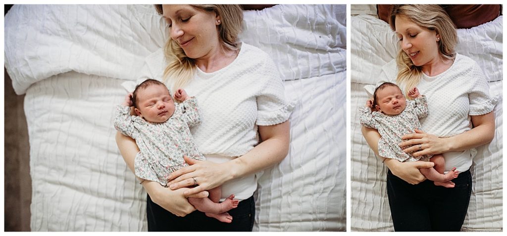 mom holds baby girl while laying on white bed during newborn pictures