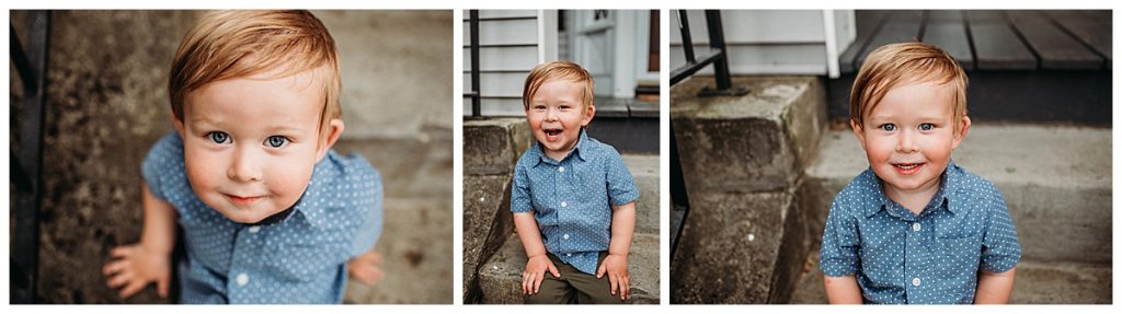 little boy smiles for camera sitting on front steps