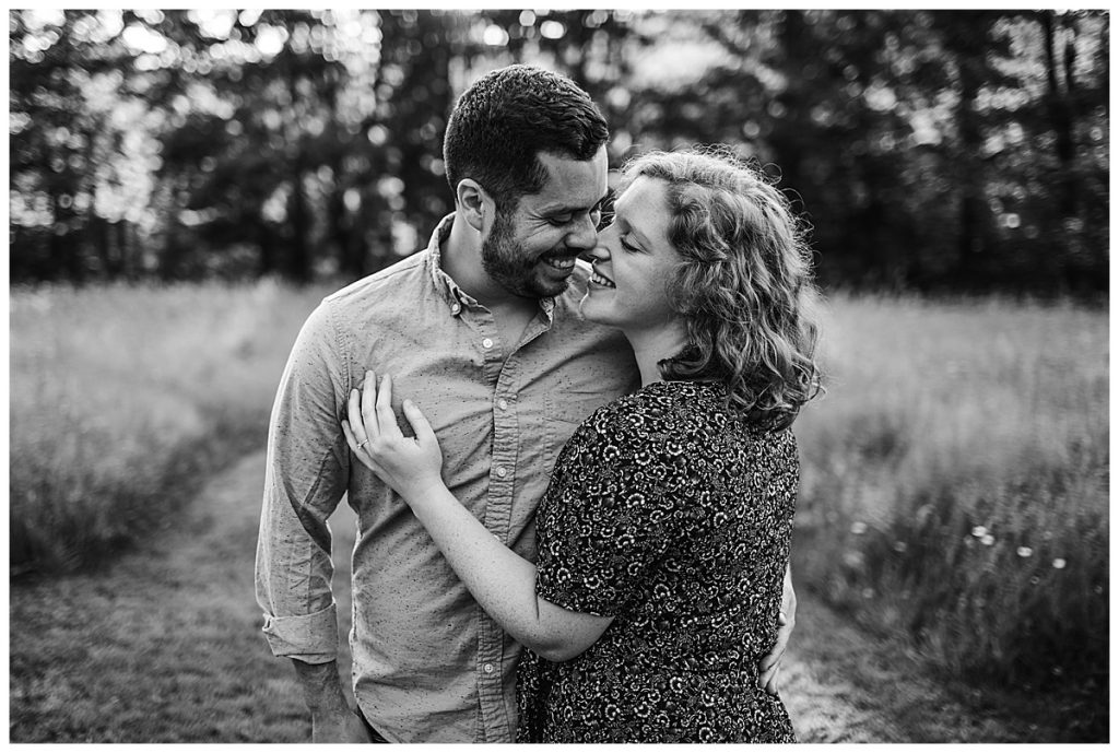 black and white portrait of couple laughing during engagement photos