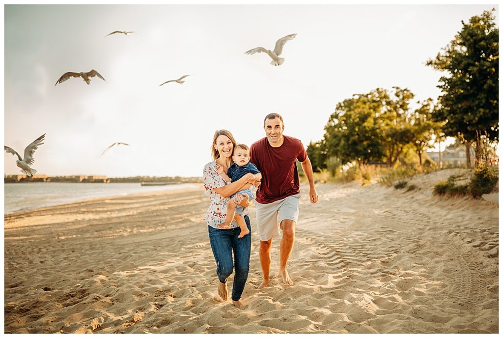 family runs from seagulls during family photo session
