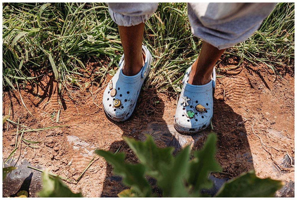 crocs adorned with funny charms on a farm