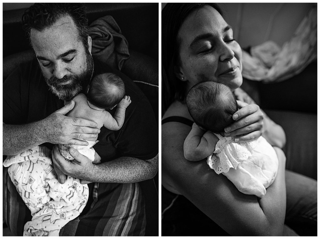 mother and father snuggle newborn baby daughter