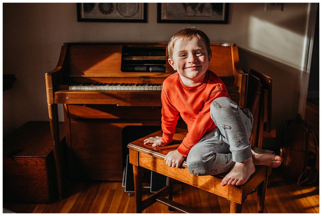 portrait of a boy on a piano bench