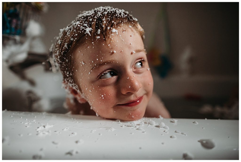 boy in tub covered in shaving cream