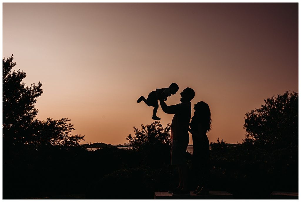 silhouette of a family of three with 2 year old boy 