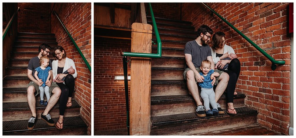 family sits on stairs of city apartment building during city family photoshoot