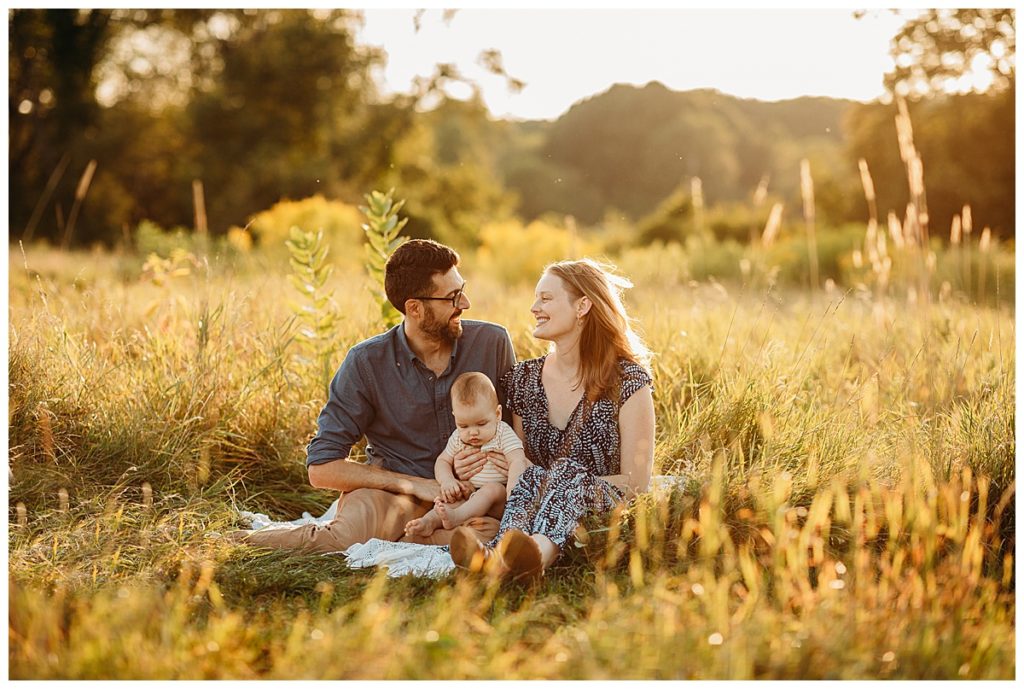 family sits in field with golden grasses during family pictures
