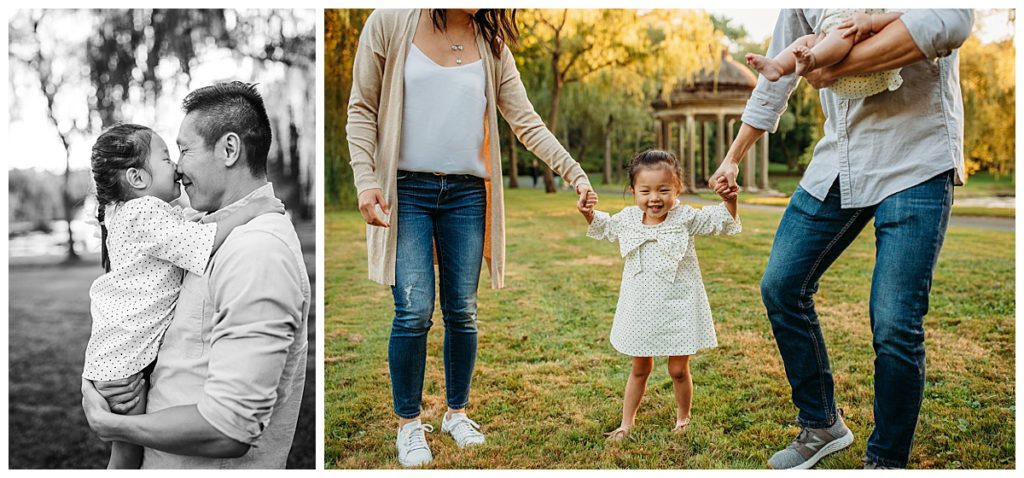little girl holds parents hands and smiles at camera during photo shoot in boston