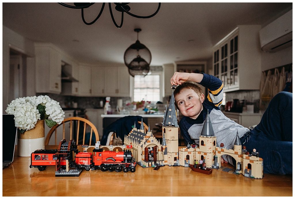 a boy putting legos together during pandemic times