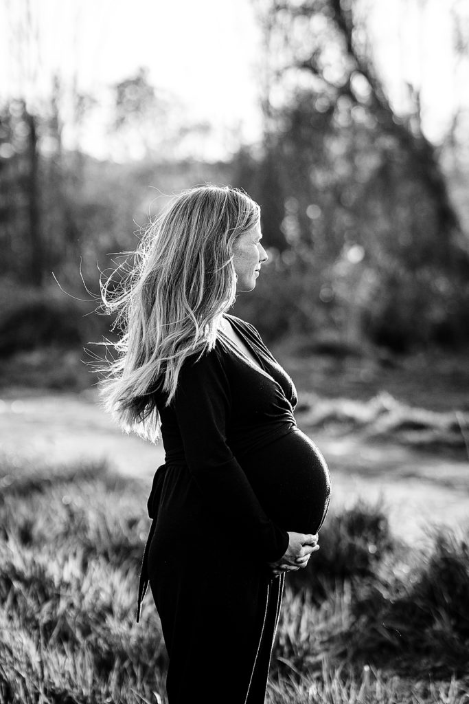black and white image of a pregnant mother at maternity photo shoot