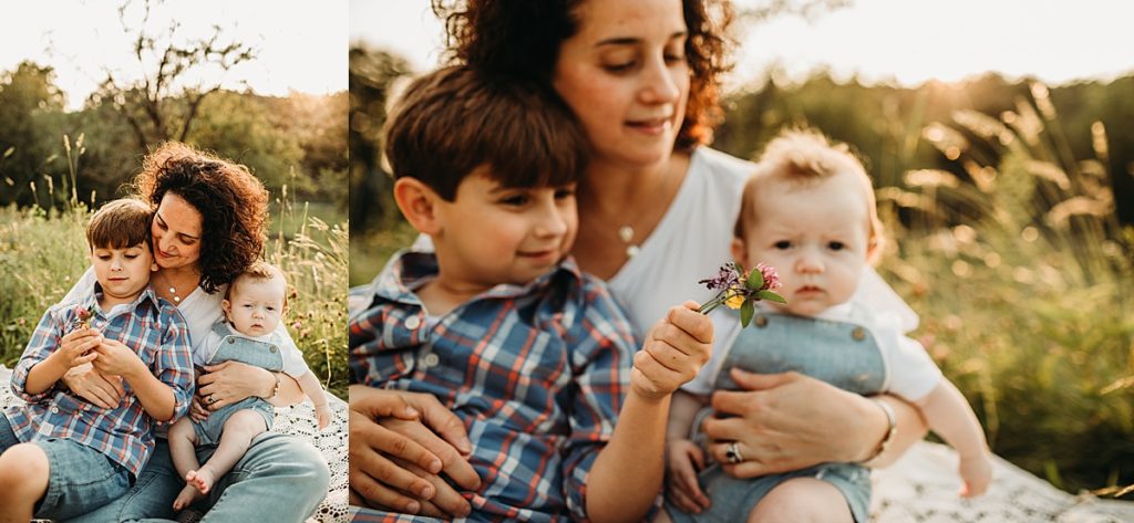 brother hands flowers to mother during outdoor baby photos