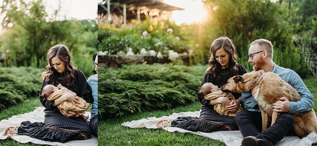 new parents and dog look at newborn outdoors