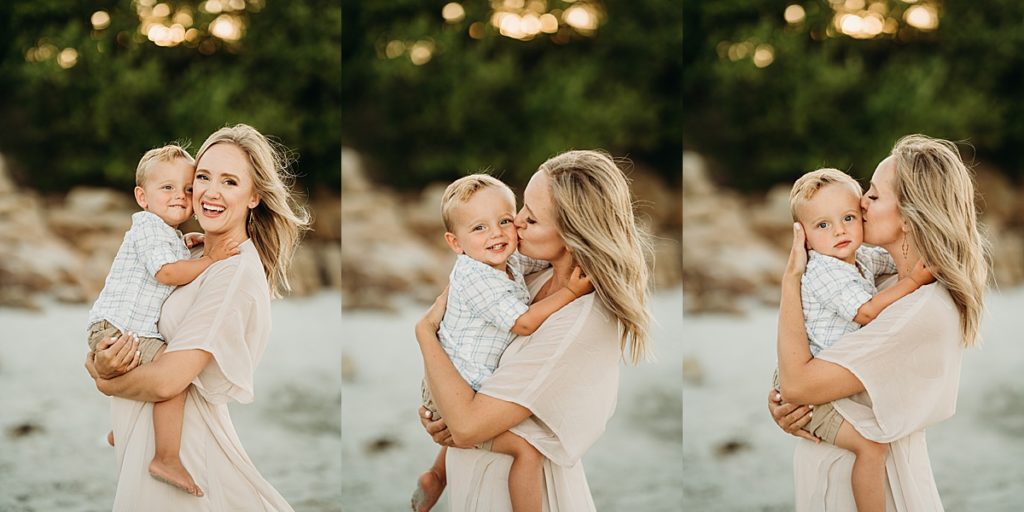 mother holds toddler for sunset images on the beach