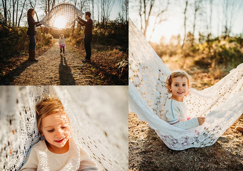 little girl runs under blanket during photoshoot