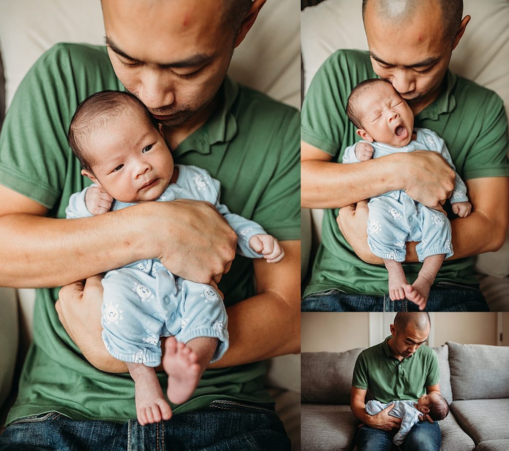 dad holds yawning baby boy