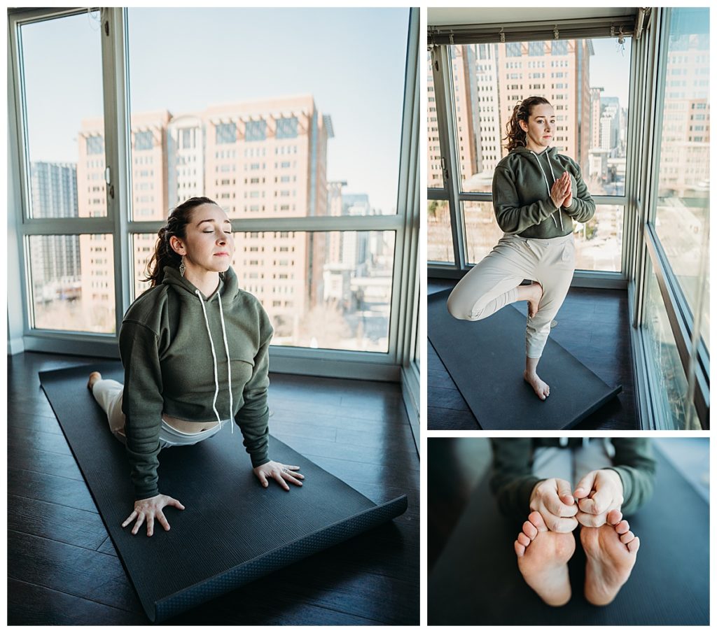 woman does yoga in front of wall of windows in boston